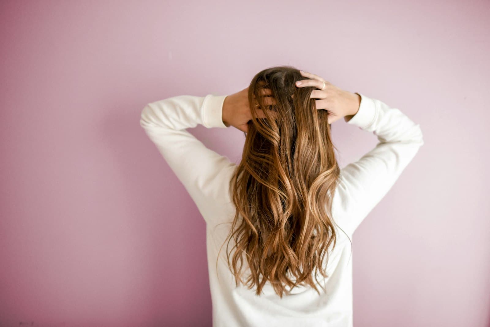 Hairdresser working on long hair in a hair salon
